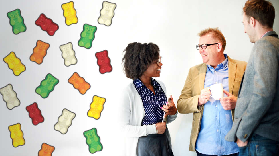 Three employees talking and laughing at HARIBO